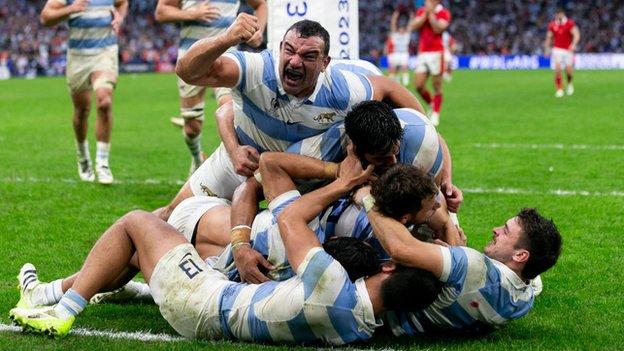 Argentina players in a huddle after scoring