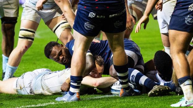 Stu Townsend stretches to score a try under a tackle