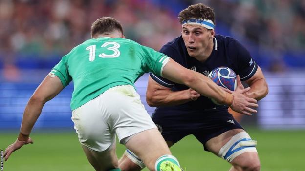 Rory Darge tries to beat an Ireland defender while playing for Scotland