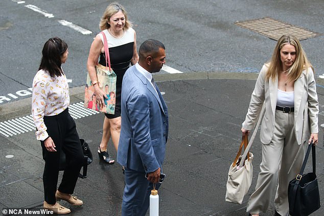 The 35-year-old (pictured centre outside court on Tuesday) repeatedly apologised to his alleged victim during the call, which he was unaware was being recorded by police