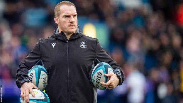 Gethin Jenkins gathers up rugby balls before a Cardiff game