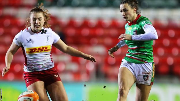 Leicester Tigers' Tess Feury (right) chases the ball in a match against Harlequins