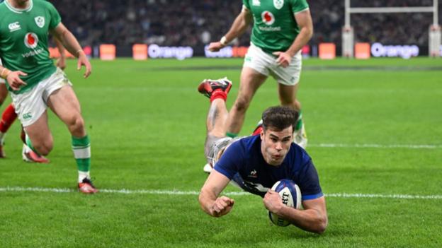 France wing Damian Penaud dives in to score a try versus Ireland