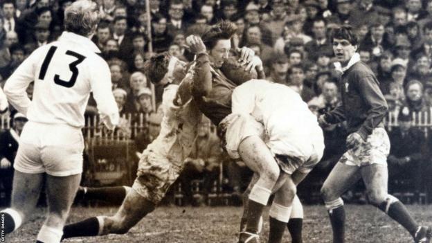 JPR Williams tackled against England as Barry John looks on in 1969