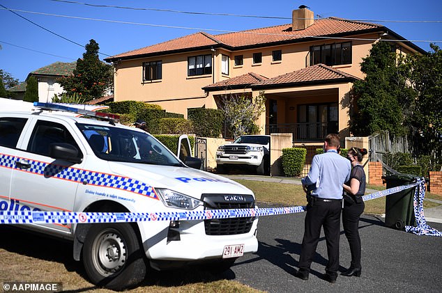 The judge hearing the case said the crime scene photos were so grisly he could not cope with looking at them (pictured, police at Kefu's house after the home invasion)