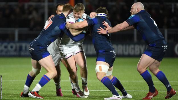 Ospreys centre Keiran Williams is stopped by Edinburgh defence