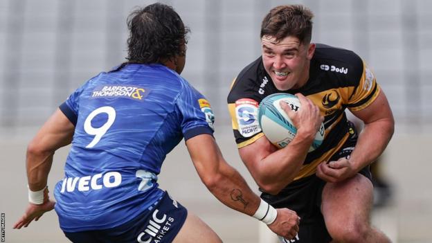 Sam Spink, of Western Force, is challenged by Sam Nock, of Blues