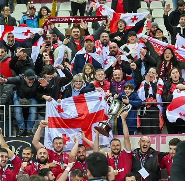 The Georgian players lift the trophy in front of supporters after triumphing in Paris on Sunday