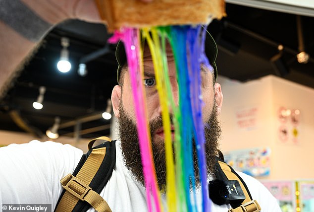 Marler looks through the strings of cheese from his unique toastie during his time in Tokyo