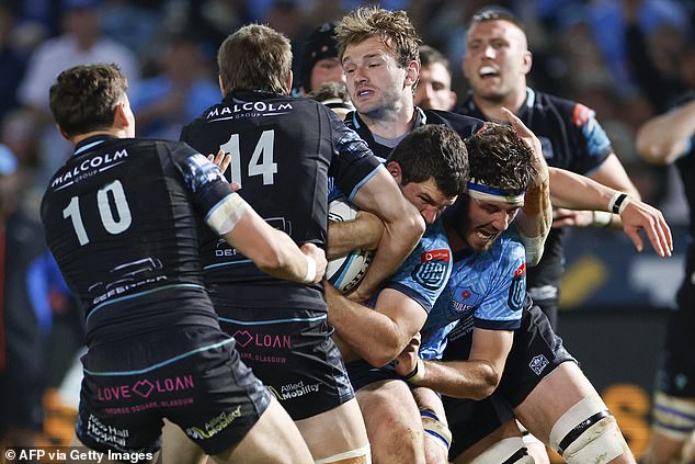 Marco van Staden  is tackled by Warriors' Argentinian wing Sebastian Cancelliere