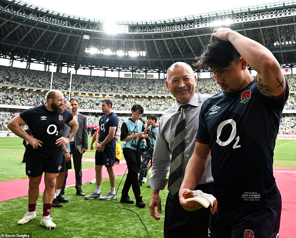 Former England coach (second right) catches up with old colleague Marcus Smith (right) who was impressive for England