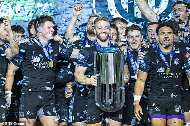 Kyle Steyn gets his hands on the United Rugby Championship trophy after Warriors beat the Bulls