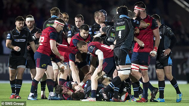 Ryan Wilson and Peter O’Mahony wrestle on the turf in 2017 as players from both sides wade in