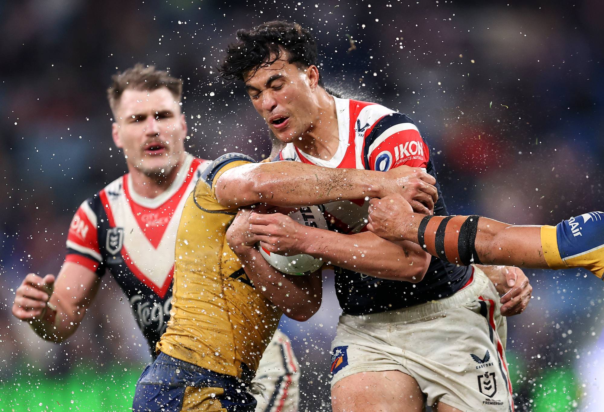 SYDNEY, AUSTRALIA - AUGUST 16: Joseph-Aukuso Sua'ali'i of the Roosters is tackled by the Eels defence during the round 24 NRL match between Sydney Roosters and Parramatta Eels at Allianz Stadium, on August 16, 2024, in Sydney, Australia. (Photo by Brendon Thorne/Getty Images)