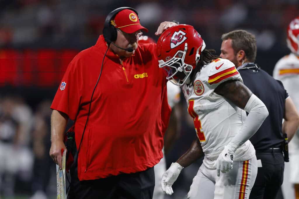 ATLANTA, GEORGIA - SEPTEMBER 22: Head coach Andy Reid of the Kansas City Chiefs speaks with Rashee Rice #4 of the Kansas City Chiefs during the third quarter against the Atlanta Falcons at Mercedes-Benz Stadium on September 22, 2024 in Atlanta, Georgia. 