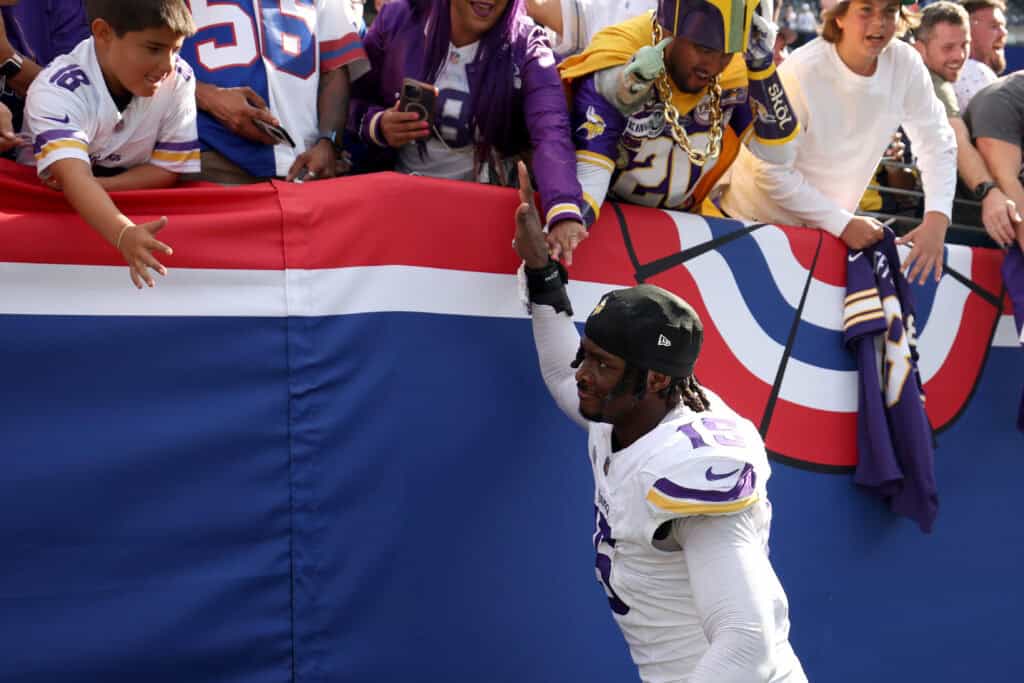 EAST RUTHERFORD, NEW JERSEY - SEPTEMBER 08: Dallas Turner #15 of the Minnesota Vikings high fives fans after defeating the New York Giants at MetLife Stadium on September 08, 2024 in East Rutherford, New Jersey.