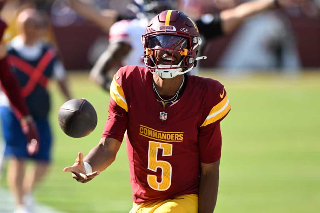 LANDOVER, MARYLAND - SEPTEMBER 15: Quarterback Jayden Daniels #5 of the Washington Commanders reacts during the fourth quarter against the New York Giants at Northwest Stadium on September 15, 2024 in Landover, Maryland. 