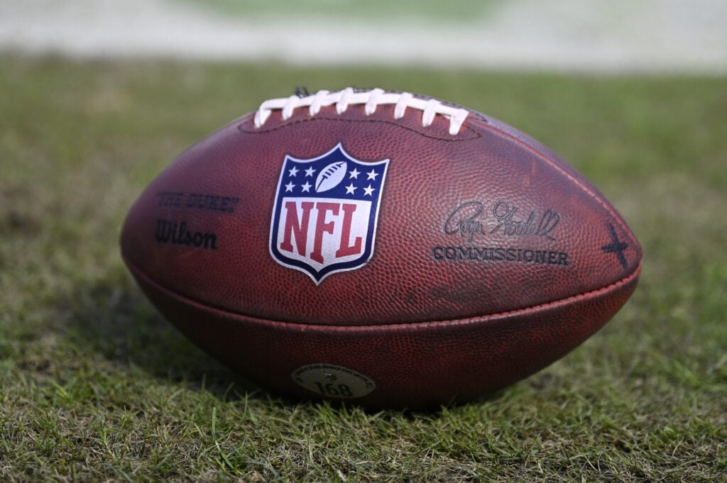 A detailed view of the NFL logo on a football prior to the game between the Minnesota Vikings and the Chicago Bears at Soldier Field on October 15, 2023 in Chicago, Illinois.