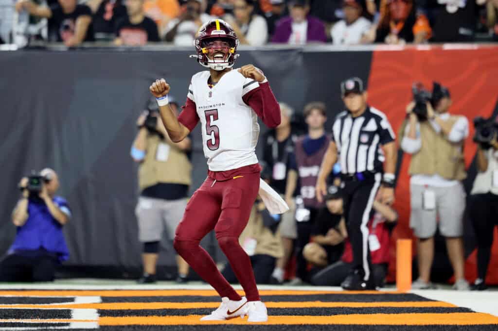 CINCINNATI, OHIO - SEPTEMBER 23: Jayden Daniels #5 of the Washington Commanders celebrates after scoring a touchdown against the Cincinnati Bengals during the second quarter at Paycor Stadium on September 23, 2024 in Cincinnati, Ohio.