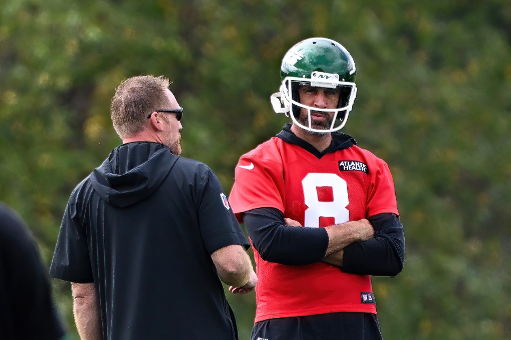 Jets passing game coordinator Todd Downing engaged in a discussion with quarterback Aaron Rodgers during a practice session in Florham Park, NJ.