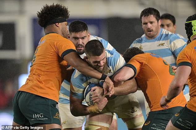 Los Pumas flanker Marcos Kremer is tackled by Australia's Wallabies flanker Rob Valetini and hooker Matt Faessler