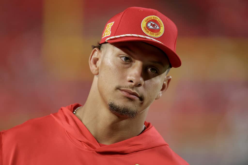 KANSAS CITY, MISSOURI - AUGUST 22: Patrick Mahomes #15 of the Kansas City Chiefs watches preseason game action against the Chicago Bears at GEHA Field at Arrowhead Stadium on August 22, 2024 in Kansas City, Missouri.