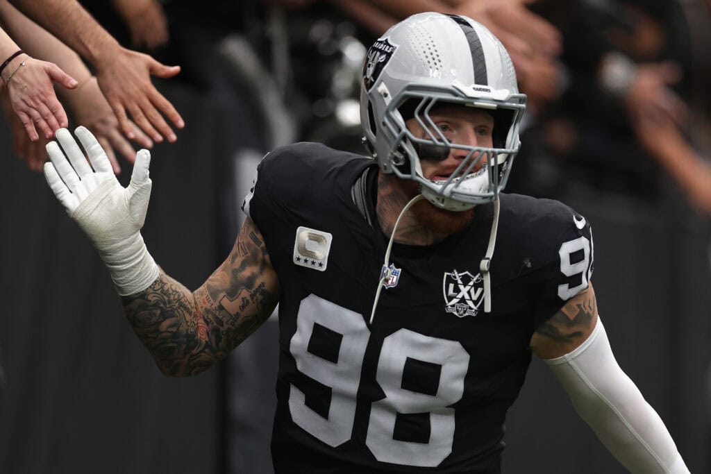 LAS VEGAS, NEVADA - OCTOBER 27:  Maxx Crosby #98 of the Las Vegas Raiders high fives fans as he runs onto the field during the NFL game against the Kansas City Chiefs at Allegiant Stadium on October 27, 2024 in Las Vegas, Nevada. The Chiefs defeated the Raiders 27-20. 