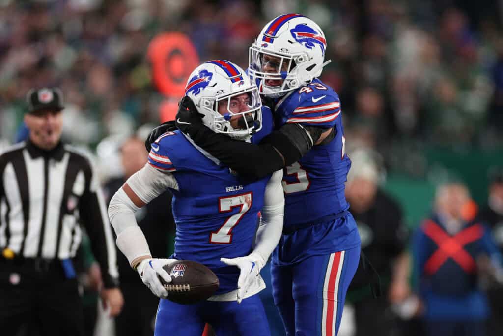 EAST RUTHERFORD, NEW JERSEY - OCTOBER 14: Taron Johnson #7 of the Buffalo Bills celebrates an interception with Terrel Bernard #43 during the fourth quarter against the New York Jets at MetLife Stadium on October 14, 2024 in East Rutherford, New Jersey.