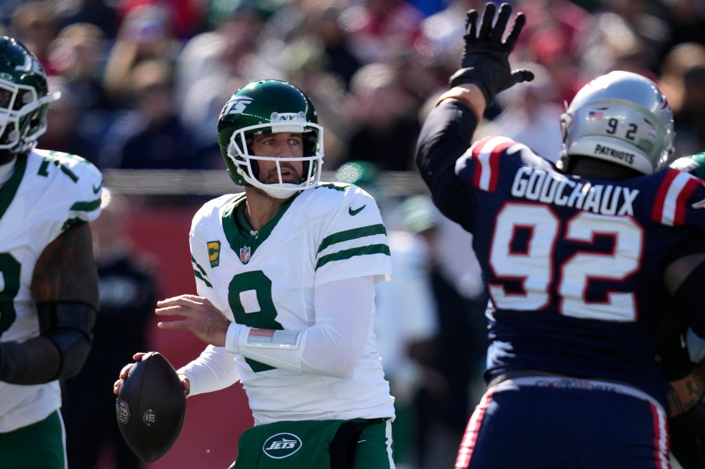 Aaron Rodgers is pressured by Davon Godchaux during the Jets' Week 8 loss to the Patriots.