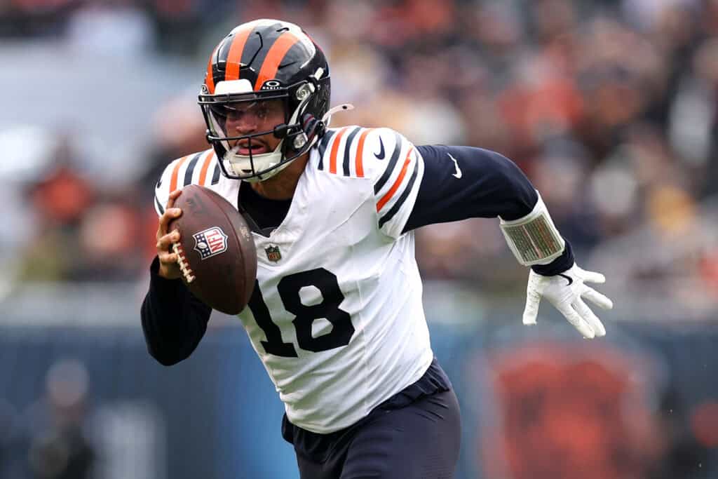 CHICAGO, ILLINOIS - NOVEMBER 24: Caleb Williams #18 of the Chicago Bears runs the ball against the Minnesota Vikings during the fourth quarter at Soldier Field on November 24, 2024 in Chicago, Illinois. 