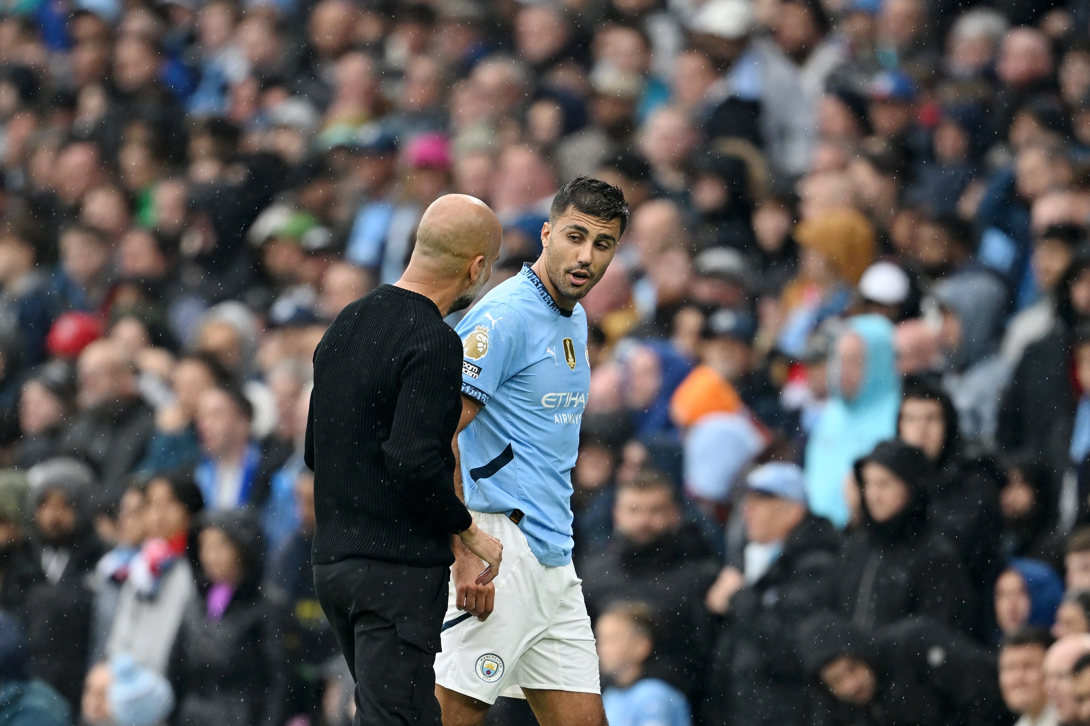 Rodri talks to Pep Guardiola