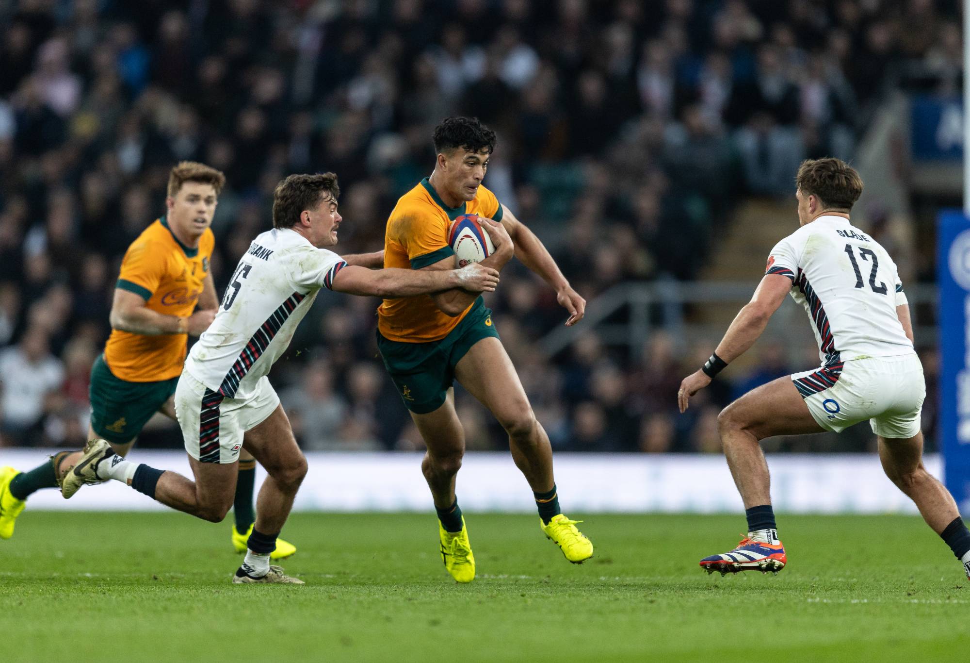 Australia's Joseph-Aukuso Sua'ali'i (centre) competing with England's George Furbank (left) and Henry Slade during the Autumn Nations Series 2025 match between England and Australia at Allianz Stadium on November 09, 2024 in London, England. (Photo by Andrew Kearns - CameraSport via Getty Images)