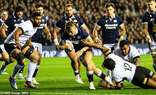 Kyle Rowe charges through the Fijian defence to open the floodgates at Murrayfield