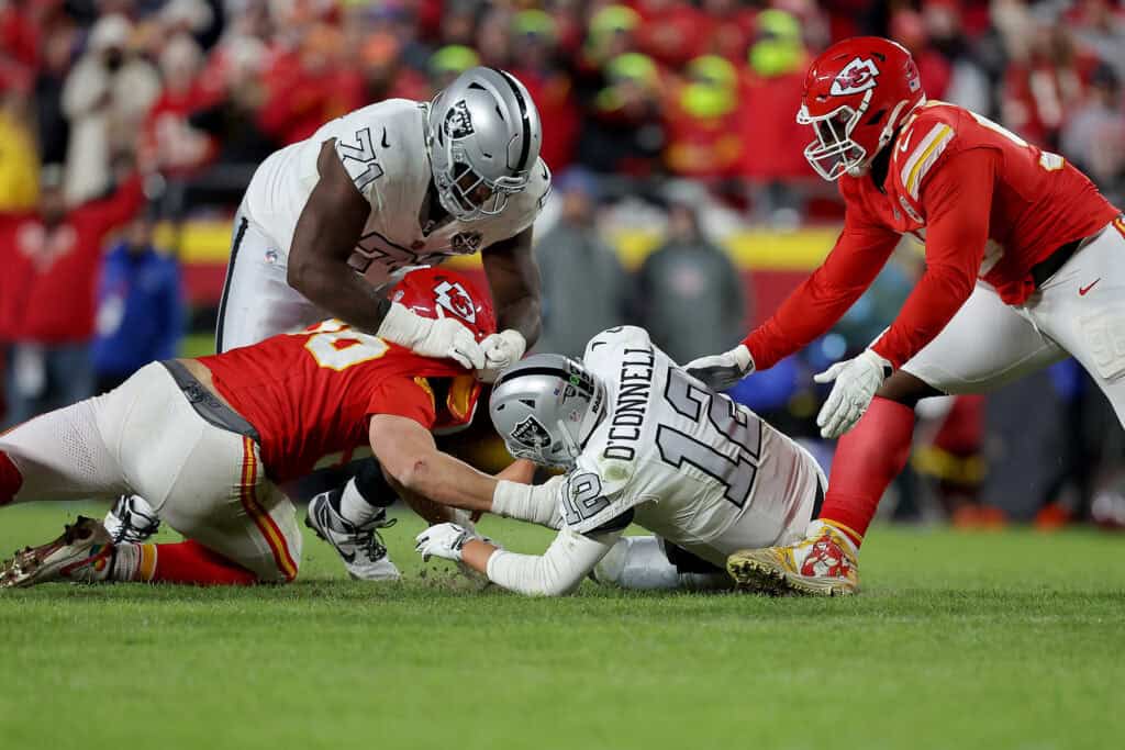 KANSAS CITY, MISSOURI - NOVEMBER 29: Aidan O'Connell #12 of the Las Vegas Raiders loses the ball on an early snap that was recovered by the Kansas City Chiefs late in the fourth quarter at GEHA Field at Arrowhead Stadium on November 29, 2024 in Kansas City, Missouri.