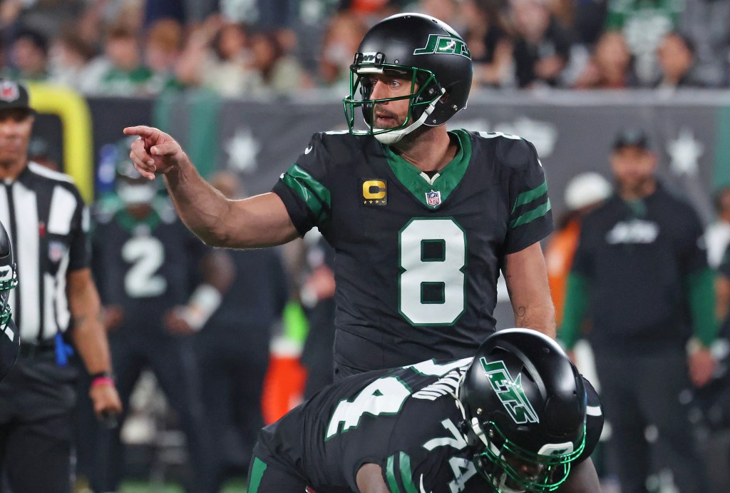 Aaron Rodgers calls out a play during the Jets' 21-13 comeback win over the Texans on Oct. 31, 2024.