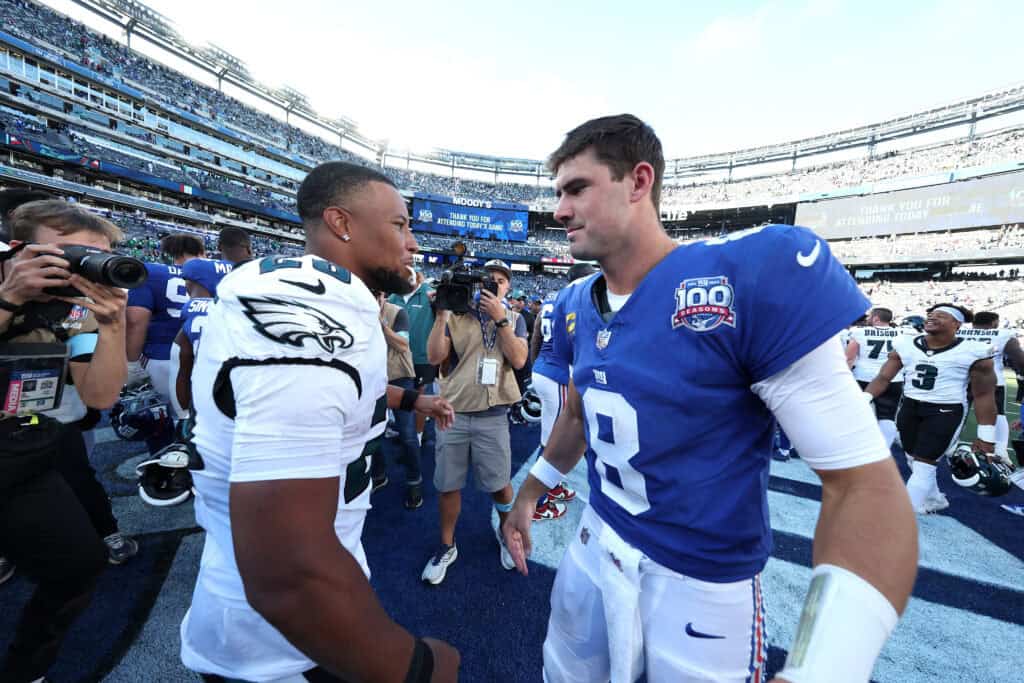 EAST RUTHERFORD, NEW JERSEY - OCTOBER 20: Saquon Barkley #26 of the Philadelphia Eagles shakes hands with Daniel Jones #8 of the New York Giants following the game at MetLife Stadium on October 20, 2024 in East Rutherford, New Jersey. Philadelphia defeated New York 28-3.