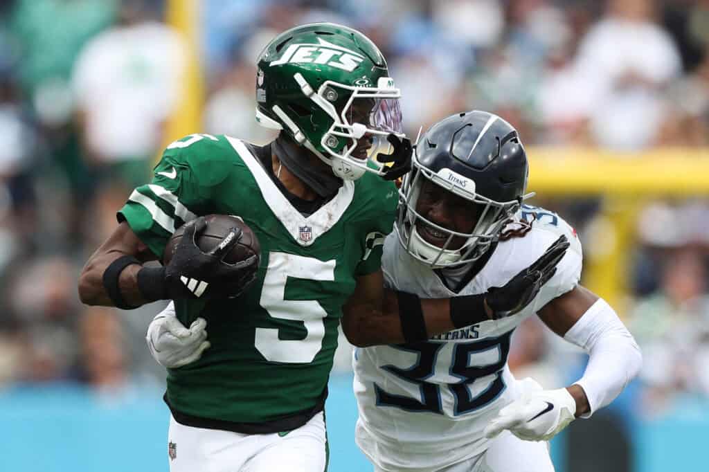 NASHVILLE, TENNESSEE - SEPTEMBER 15: Garrett Wilson #5 of the New York Jets runs with the ball as L'Jarius Sneed #38 of the Tennessee Titans looks to make a tackle during the second half at Nissan Stadium on September 15, 2024 in Nashville, Tennessee.