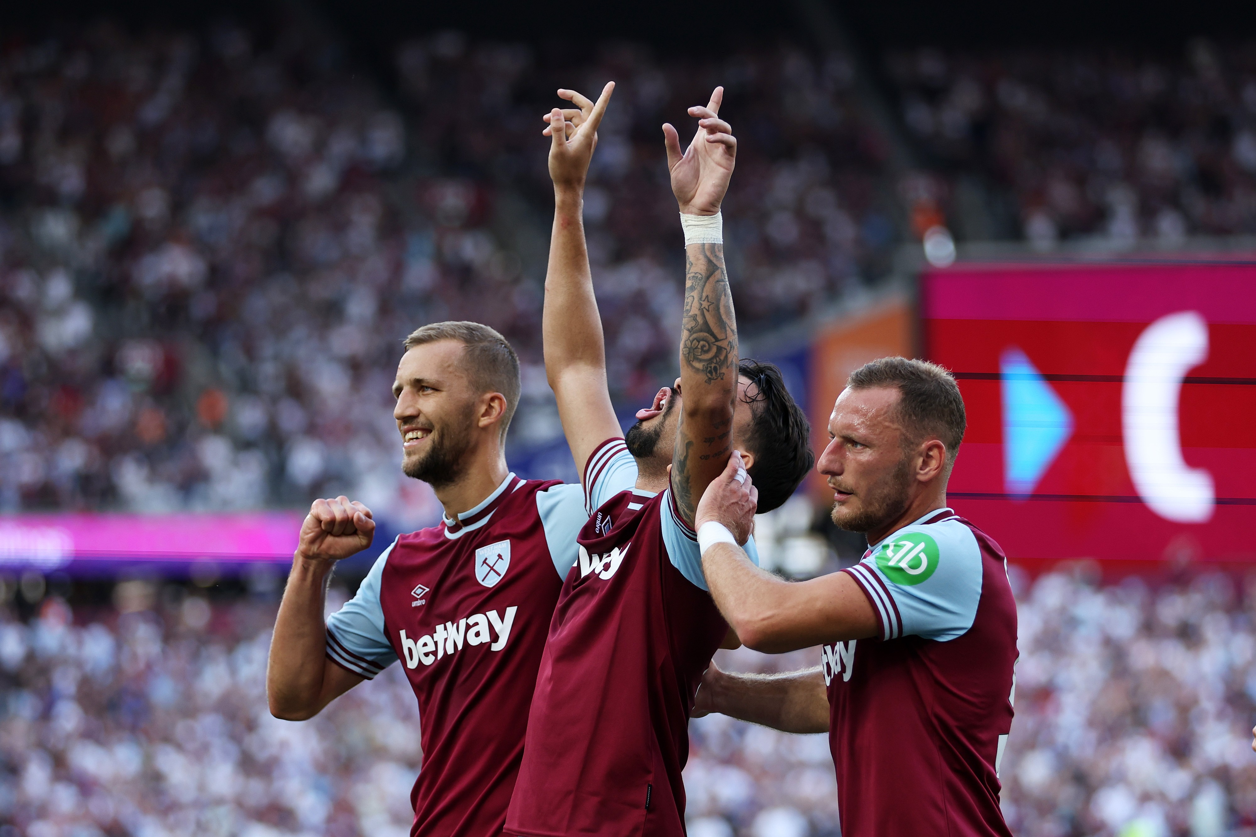 Lucas Paqueta of West Ham United celebrates scoring his team's first goal from the penalty spot with teammates Vladimir Coufal and Tomas Soucek