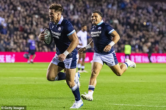 Huw Jones celebrates getting on the scoresheet against Fiji alongside Sione Tuipulotu