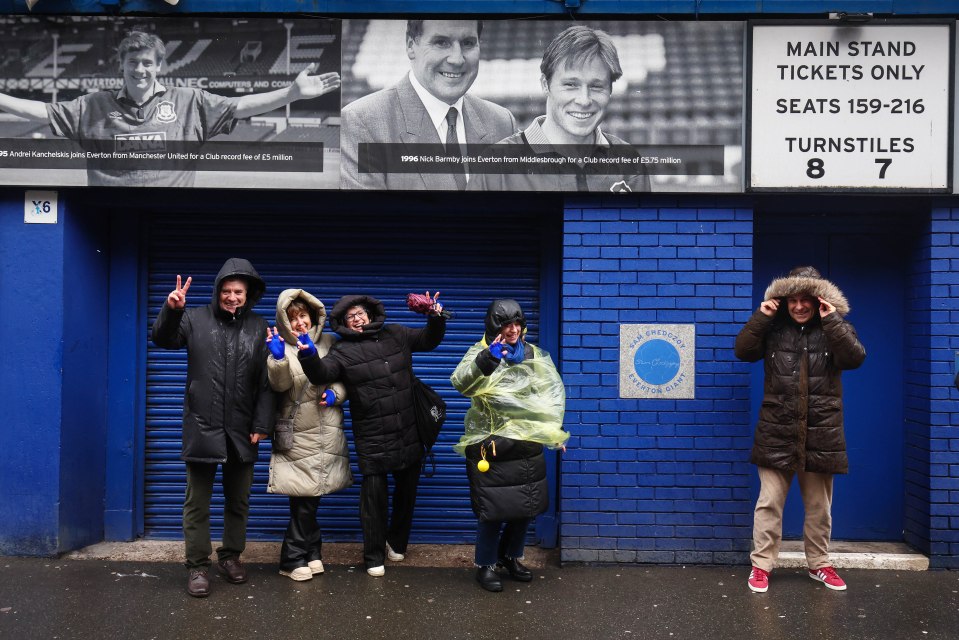 Fans taking shelter outside a drenched Goodison Park on Saturday morning