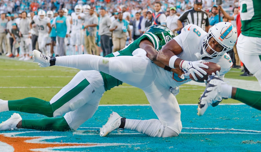 Dolphins tight end Jonnu Smith (9) scores in overtime as New York Jets safety Tony Adams, back left, defends