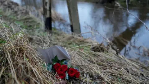 PA A bunch of red roses have been placed on the riverbank 