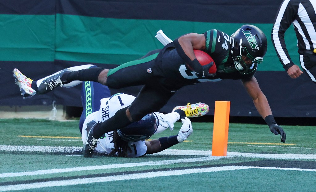 Kene Nwangwu #34 of the New York Jets falls in the end zone after being tackled by Laviska Shenault Jr. #1 of the Seattle Seahawks during the first half when the New York Jets played the Seattle Seahawks Sunday, December 1, 2024 at MetLife Stadium.